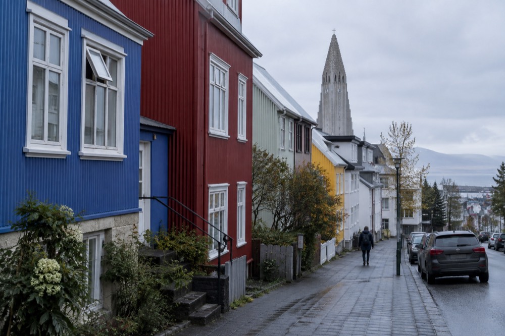 Colorful corrugated iron houses on a Reykjavik street with the church tower behind