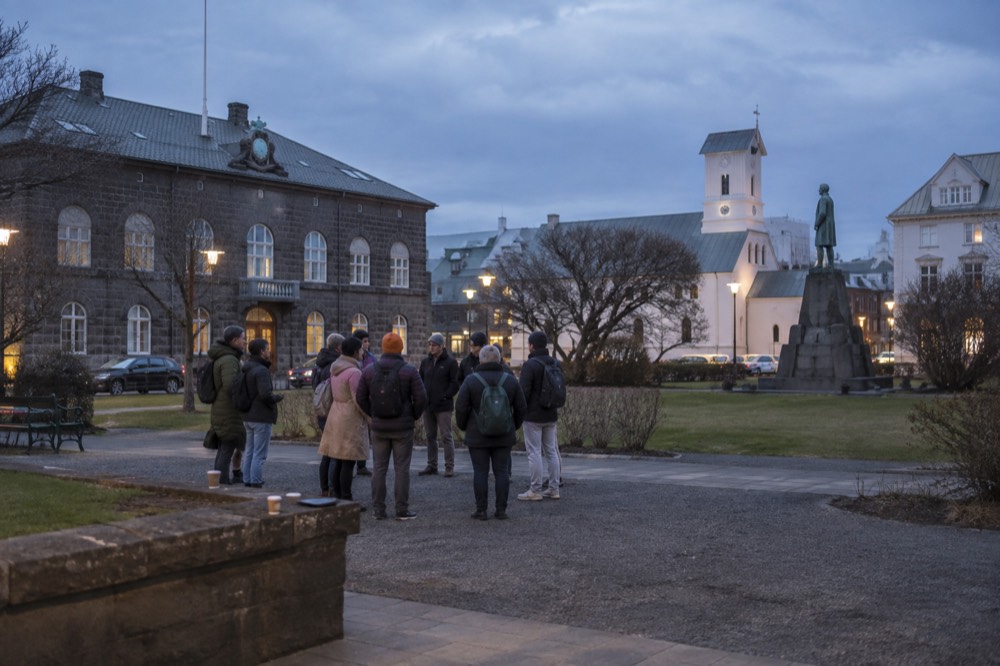 A guide with a small group standing in a Reykjavik square
