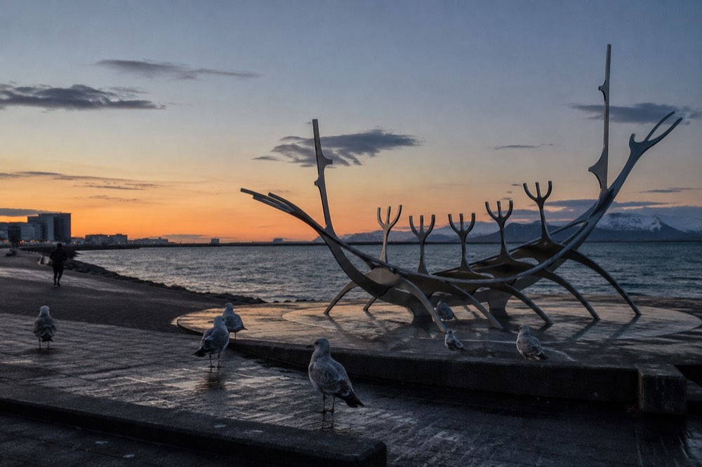 The Sun Voyager steel sculpture on Reykjavik waterfront at dusk