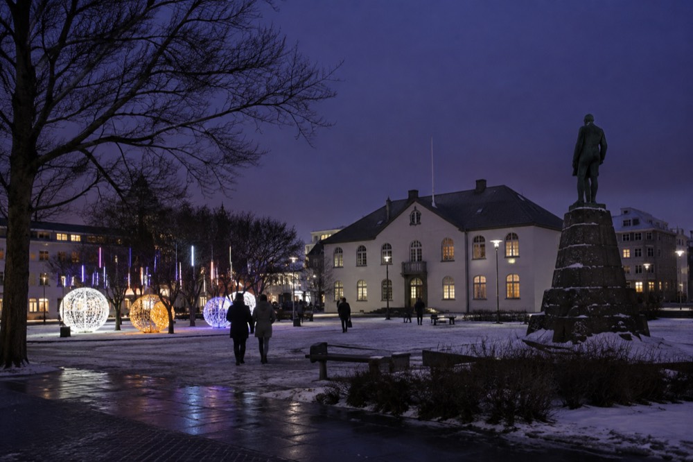 Crowd gathered in a Reykjavik square at night under festival lights