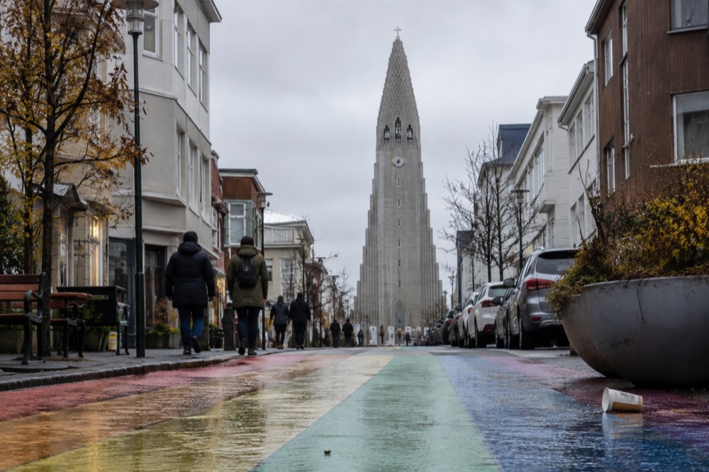 A view of Rainbow Street with colorful painted pavement leading up to Hallgrímskirkja