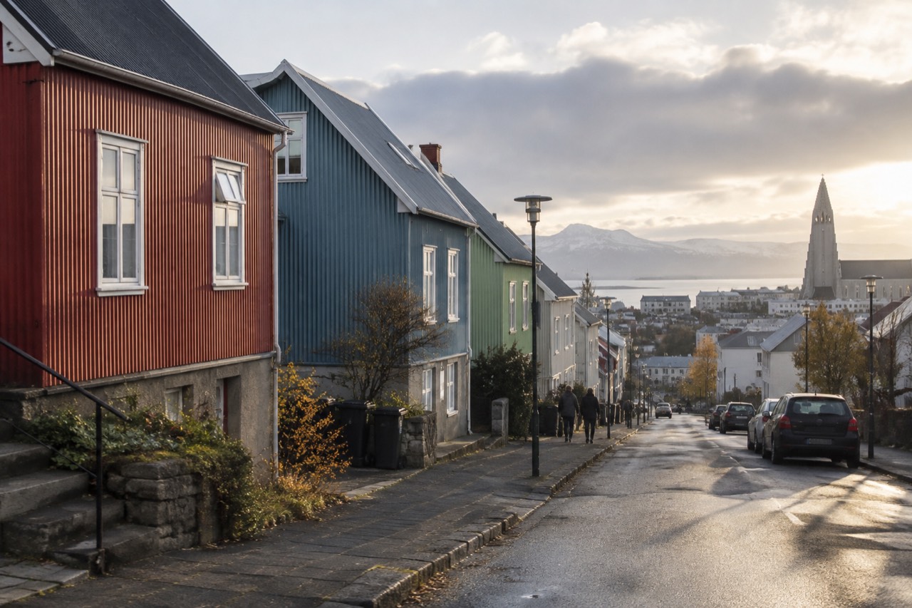 Colourful metal-clad houses on a hillside street in Reykjavik under a wide sky