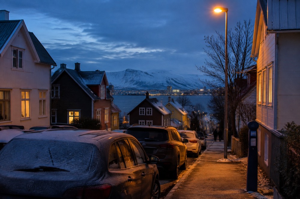 Row of parked cars along a residential Reykjavik street with a payment meter