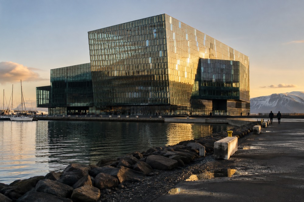 Glass facade of a concert hall reflecting low sunlight