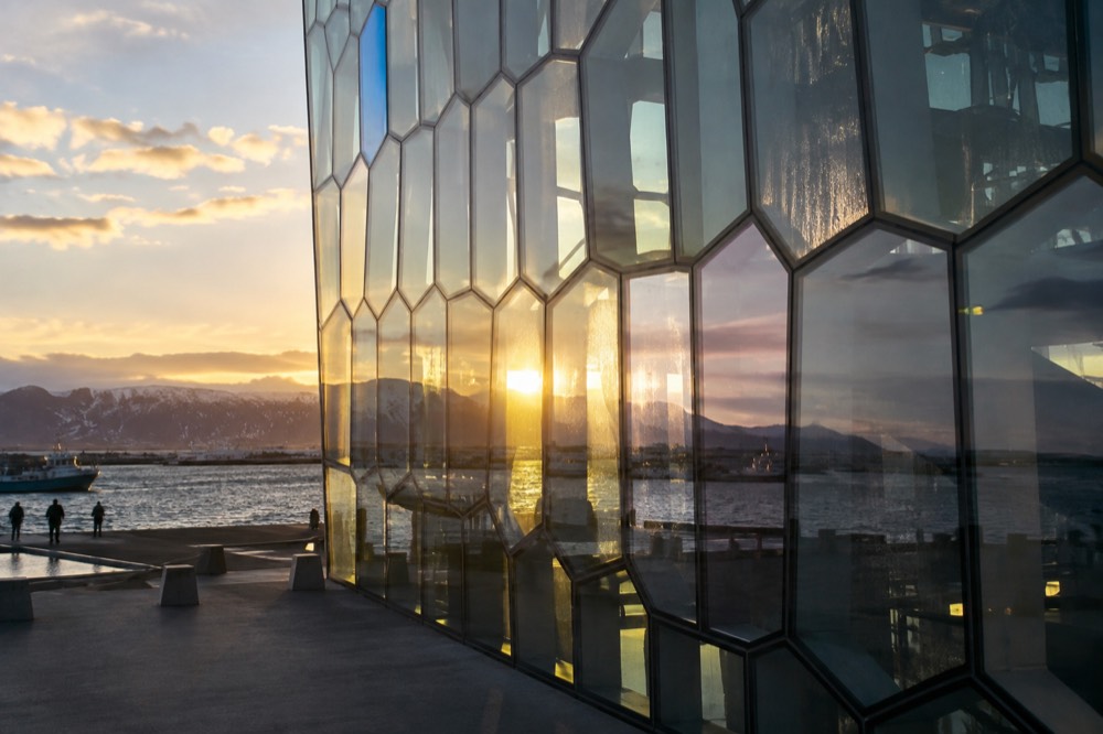The glass facade of the Harpa concert hall reflecting light