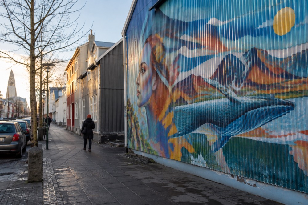 Large colourful mural painted on the side wall of a city building