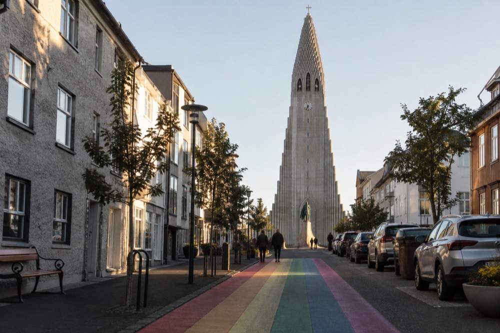 Late afternoon light on the stepped concrete facade of Hallgrímskirkja seen from Skólavörðustígur