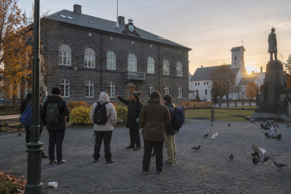 Guide speaking to a small group in a Reykjavik city square