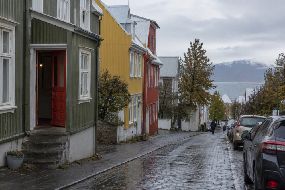 Colourful low buildings lining a sloping Reykjavik street on an overcast day