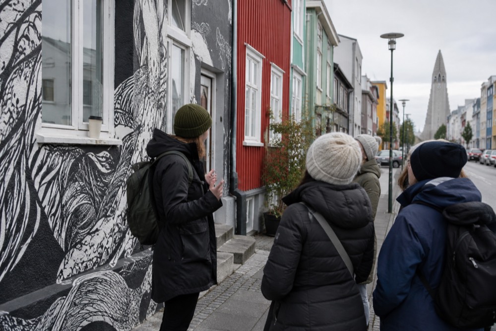 Guide speaking to a small group of visitors on a Reykjavik city street in daylight