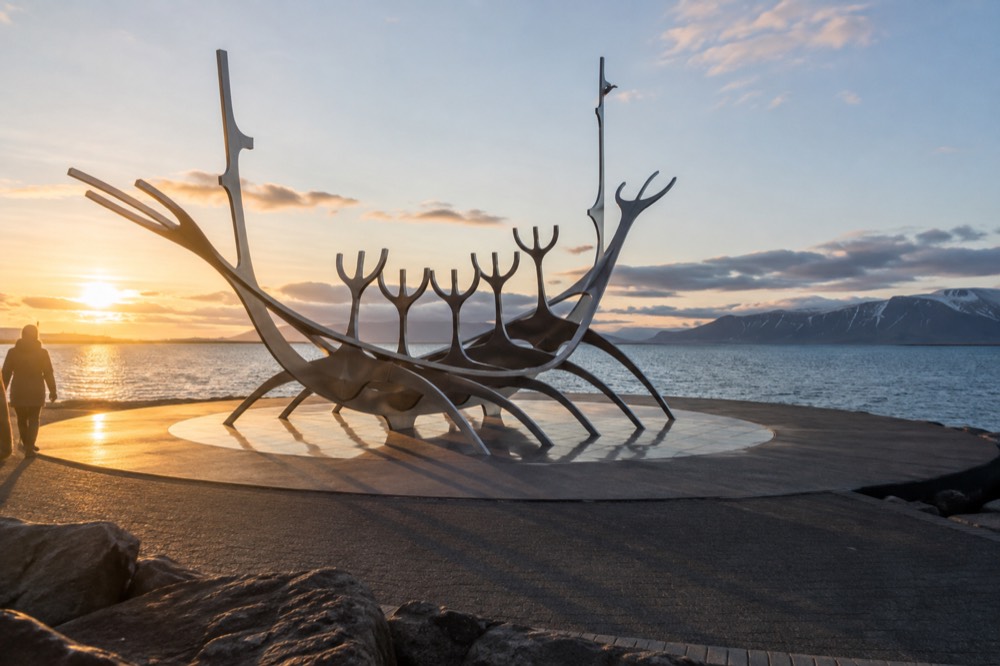 Steel sculpture of a boat on the Reykjavik seafront at golden hour